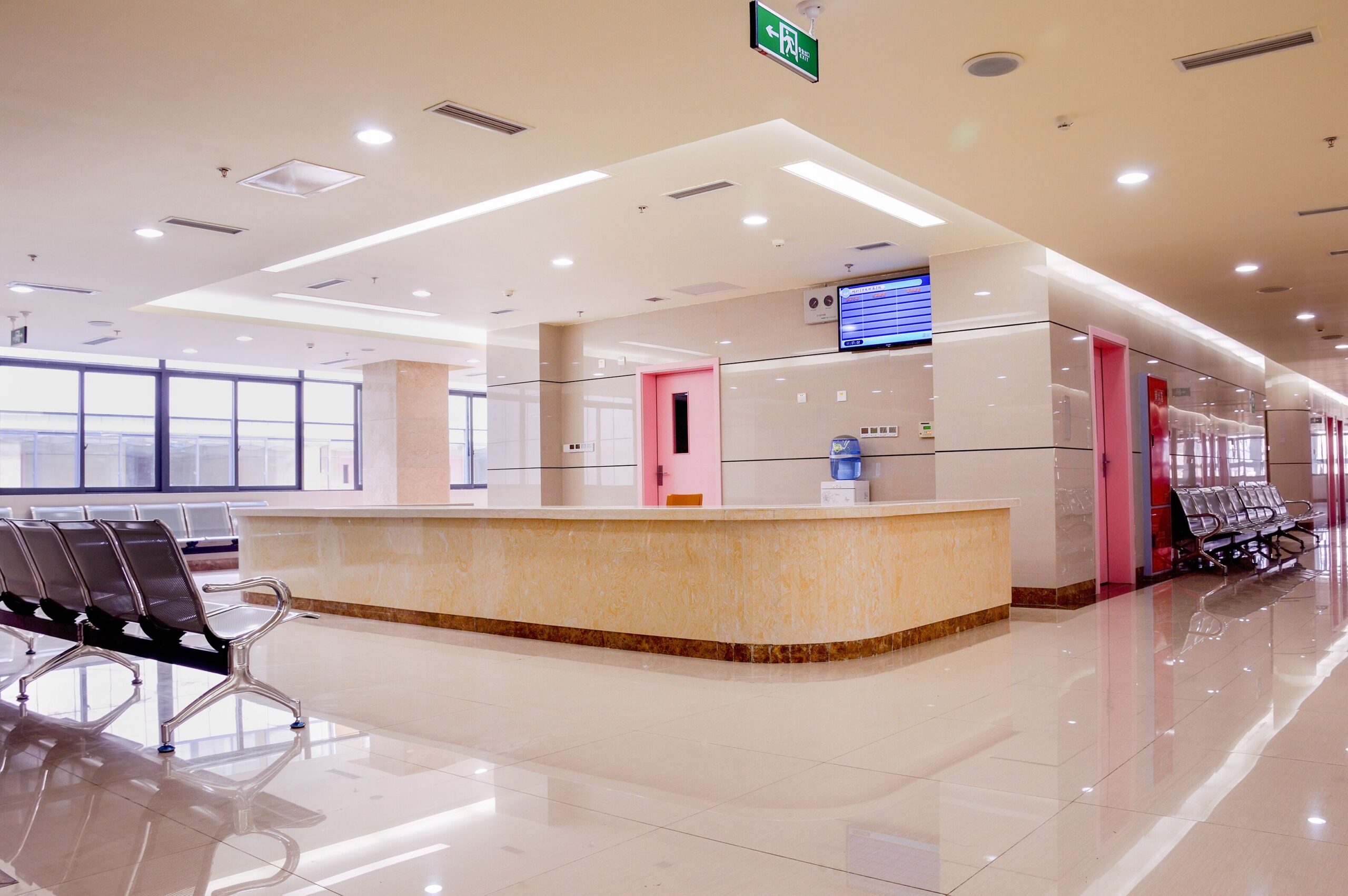 A long hallway featuring several chairs and a reception desk at the end, creating a welcoming atmosphere